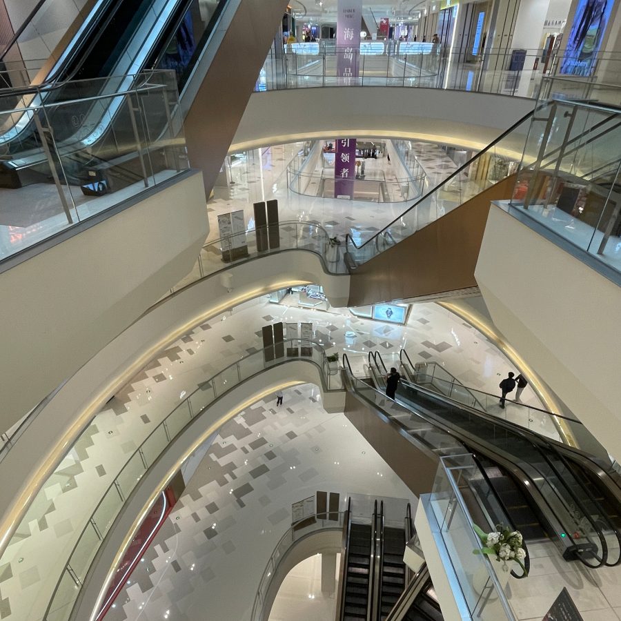 The interior of Haikou MixC features several levels of high-end shopping, accessible with escalators. 