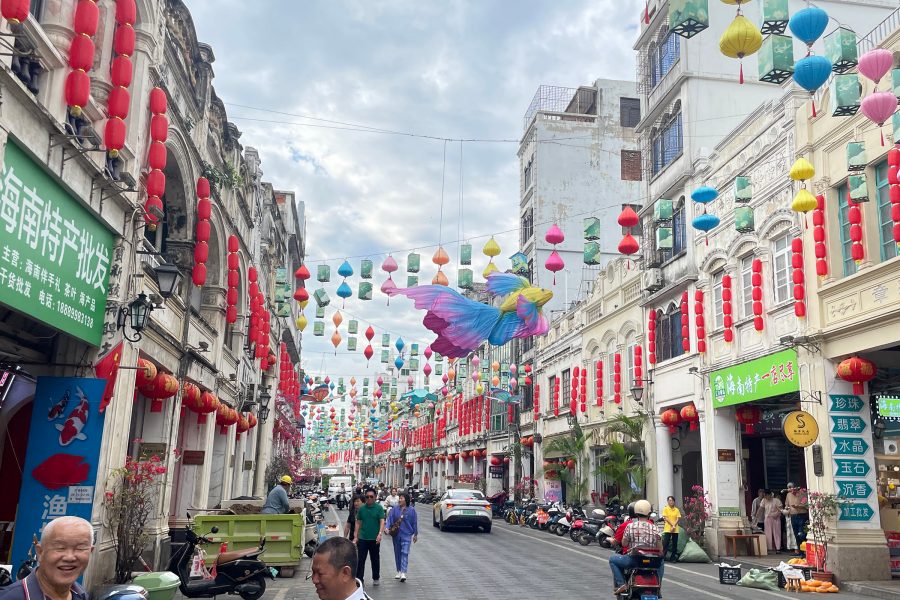 Qilou Old Street is adorned with colourful lanterns strung high up over passersby and vehicles.