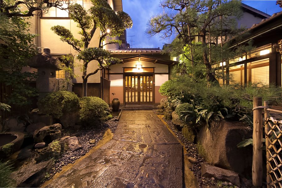 Exterior of Atsuta Horaiken, featuring a wooden boardwalk and a mini garden, in Nagoya, Japan.