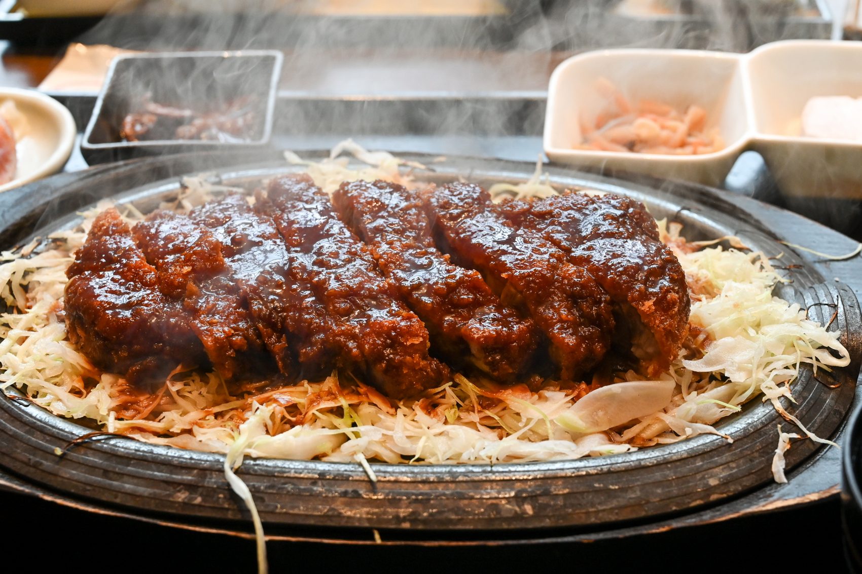 A plate of Nagoya’s specialty, miso katsu, on a bed of shredded cabbage.