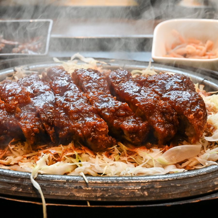 A plate of Nagoya’s specialty, miso katsu, on a bed of shredded cabbage.