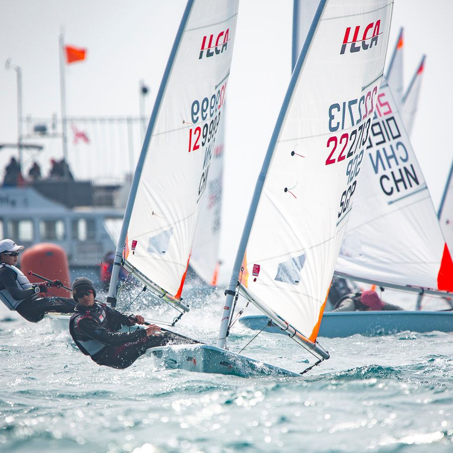 Sailors leaning far out of boats during Hong Kong Race Week.