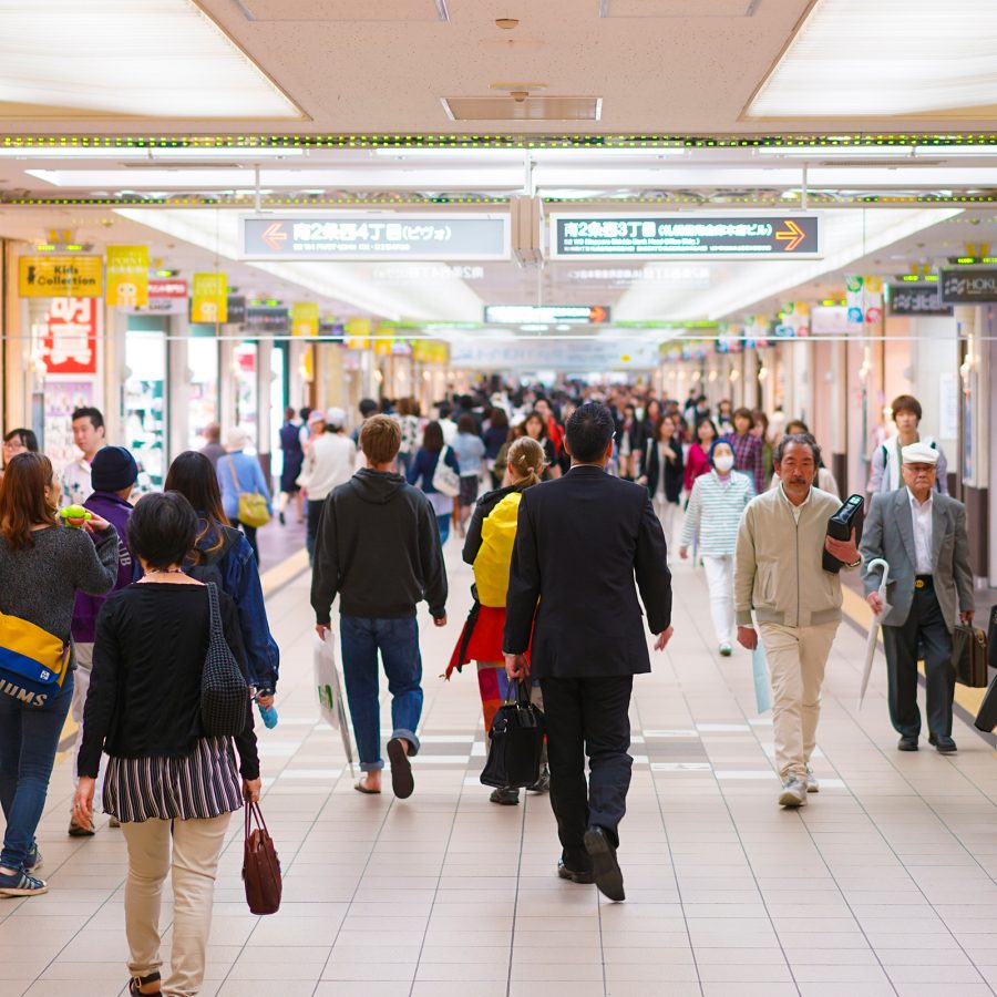 Pedestrians walk through an underground shopping mall in Sapporo. 