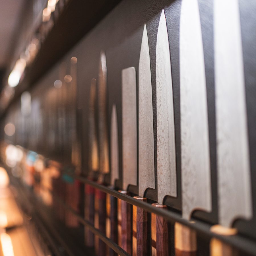 Knives shelved in neat rows gleam in the light. Miyabun in Sapporo is known for their knives and bladed tools.