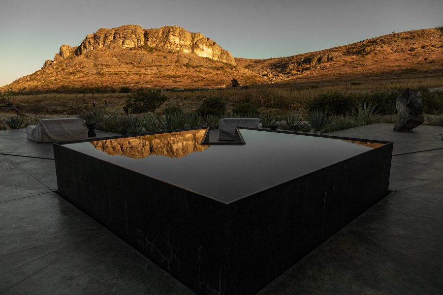 A water feature at Casa Silencio set against the backdrop of the Oaxacan landscape.