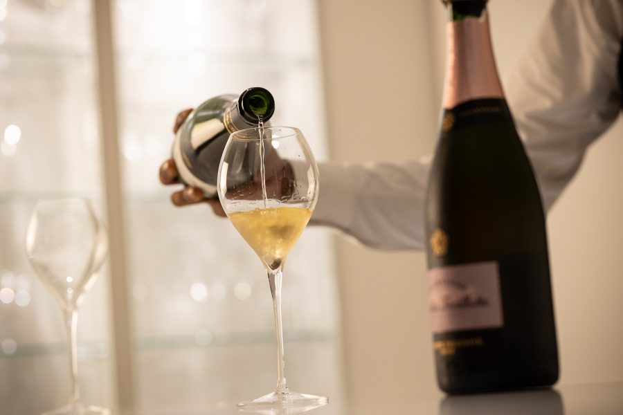 A glass of champagne being poured at the Cuvée J2 Hôtel Osaka.