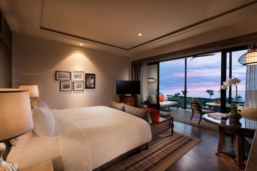 A bedroom with a large sliding glass door at Anantara Desaru Coast Resort & Villas. 