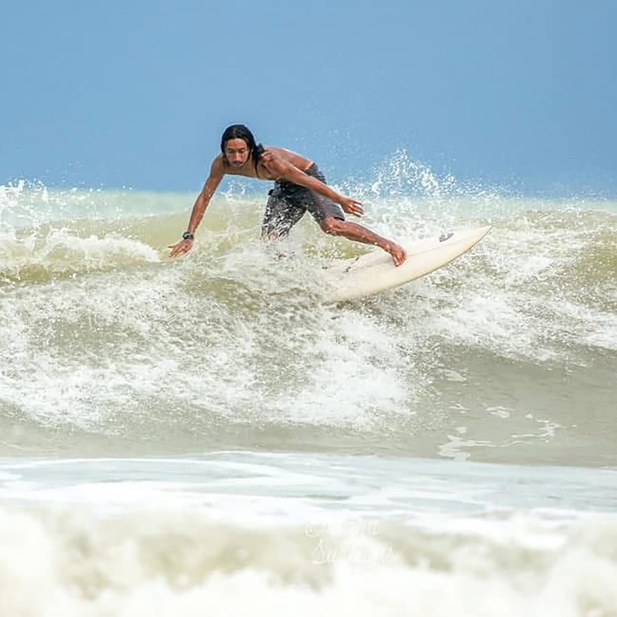 A man surfing at Desaru Coast. 