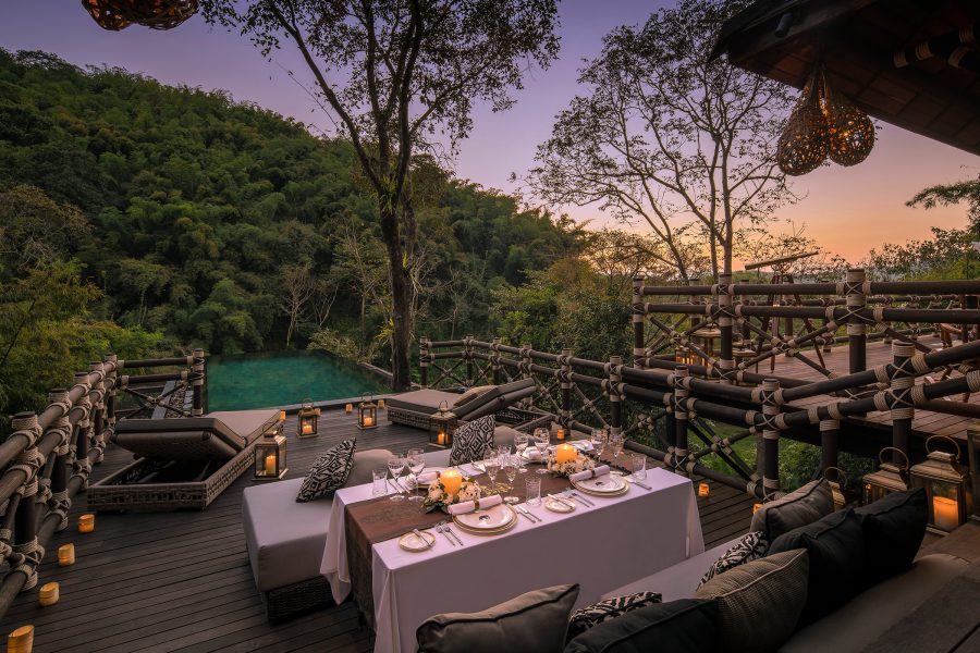 A dining area at Four Seasons Tented Camp Golden Triangle, Chiang Rai, at dusk. 