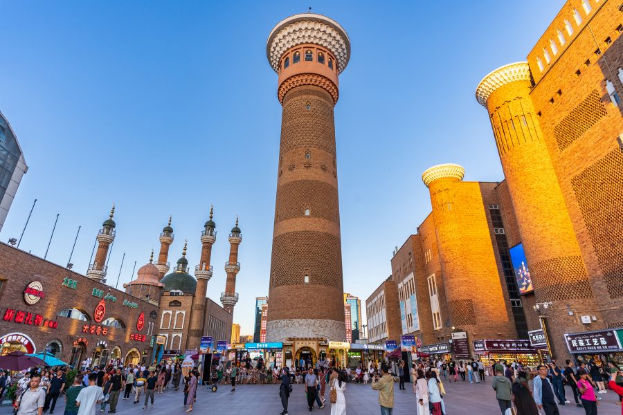 People walking around the Xinjiang International Grand Bazaar. 