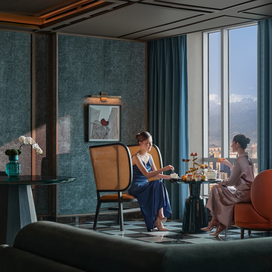 Two women sitting opposite each other having tea in Conrad Urumqi.