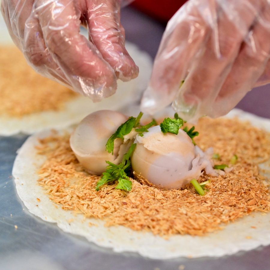 A night market vendor wearing gloves prepares a peanut ice cream roll in Taipei. 