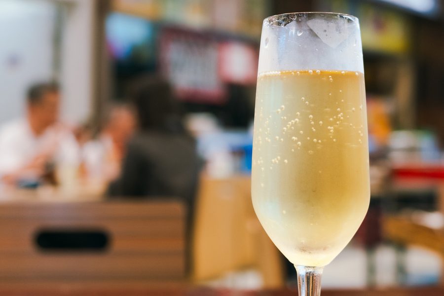 A glass of champagne on a table at ABC Kitchen in Queen Street Cooked Food Market.