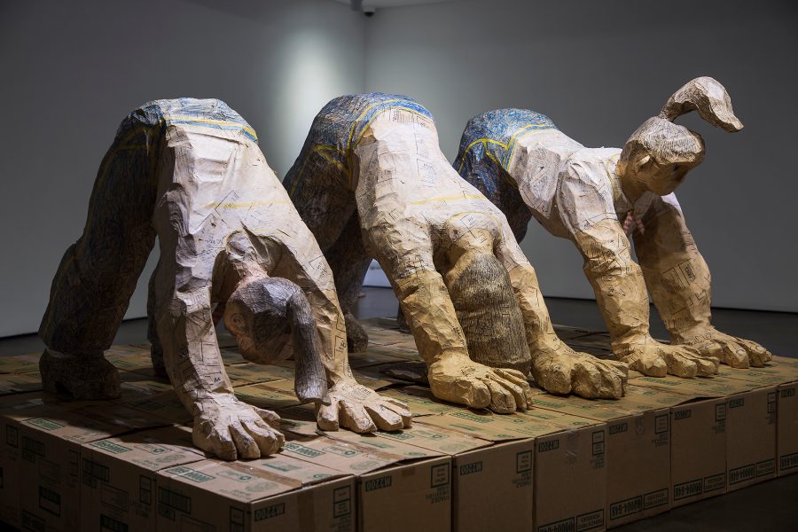 Shin Min’s Downward Facing Dog Yoga for Mcjob, a sculpture of three figures doing yoga on top of cardboard boxes. 