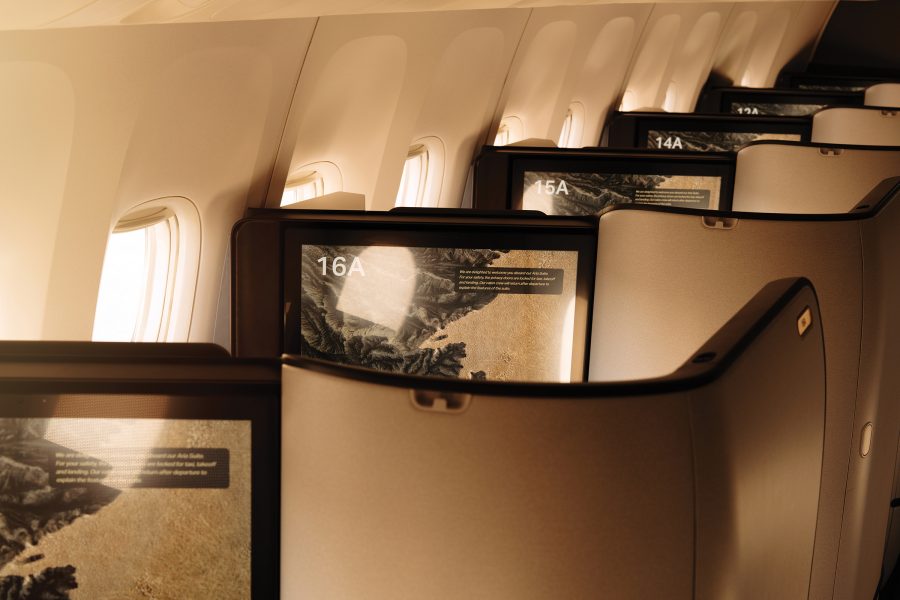 A view of television screens across seats in Cathay Pacific business class  