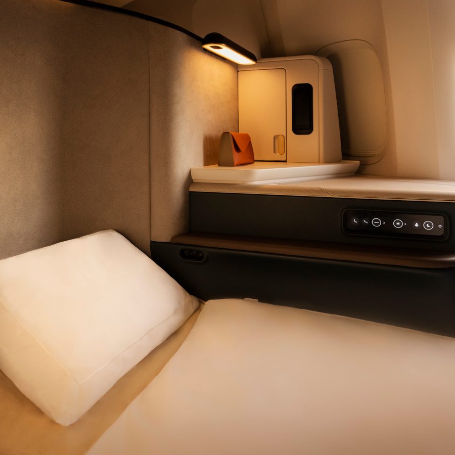A shot of Cathay’s Bamford amenity bag next to the bed in Cathay Pacific’s Business cabin Aria Suite.     