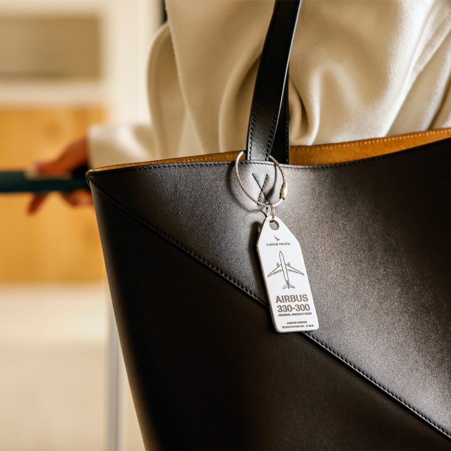 A Cathay aviation tag hangs from a handbag. 