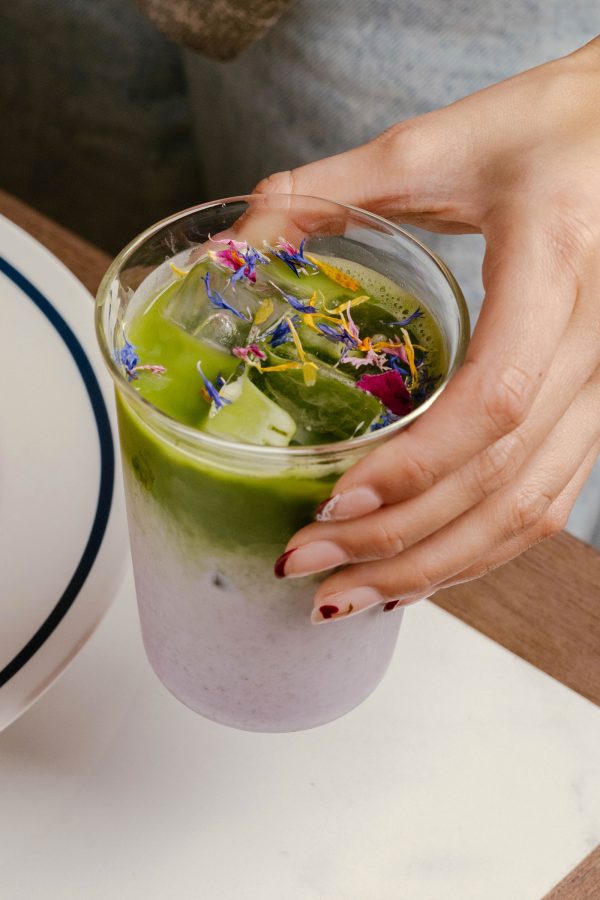 A hand holding a Purple Haze matcha latte at Bakehouse, Hong Kong.