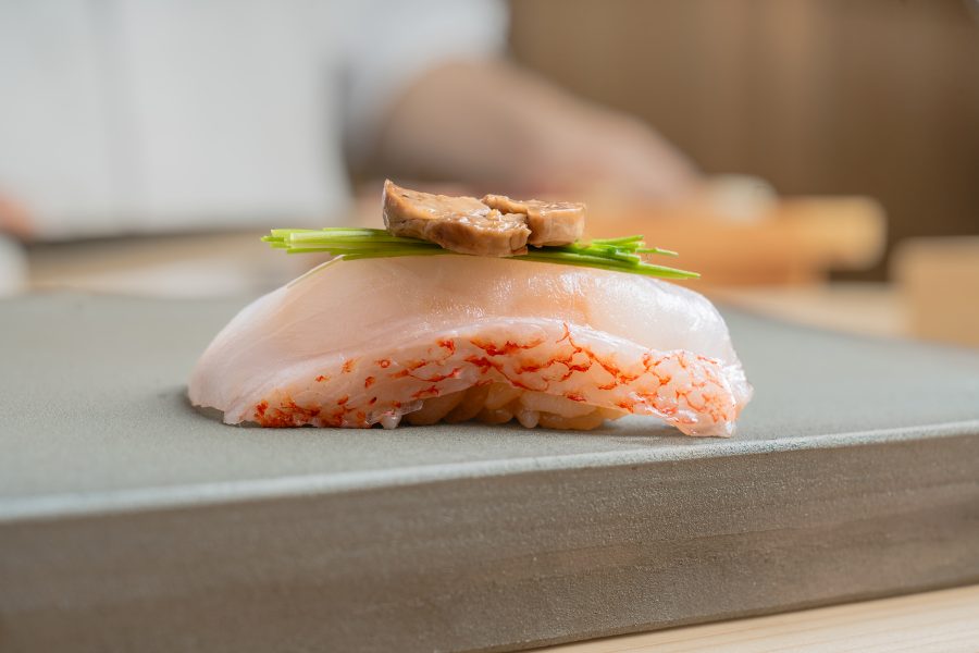 A closeup of a single piece of Kinki sushi served at Niwa, Hong Kong.