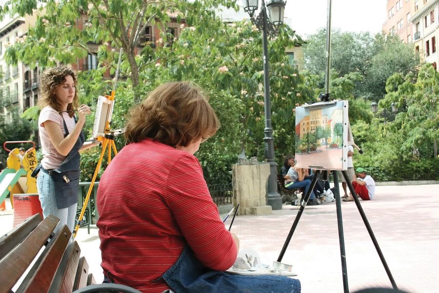 Two women painting on canvas outdoors with Your Creative Escapes art holiday in Madrid