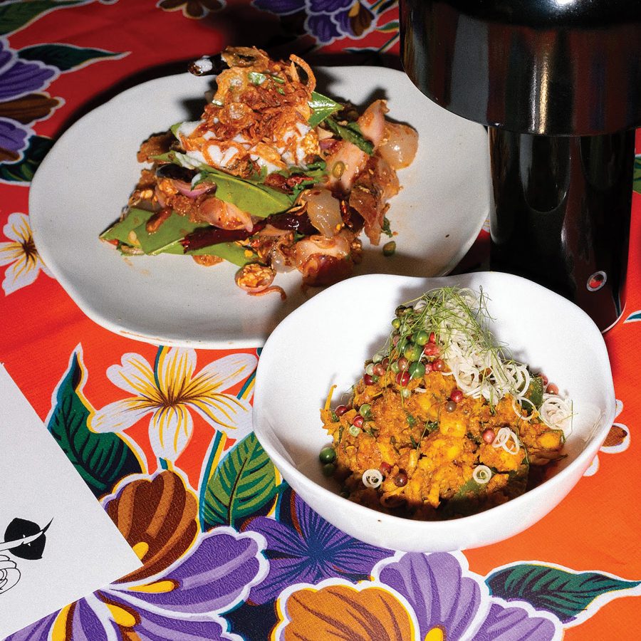 Two dishes including khua kling served on a floral tablecloth