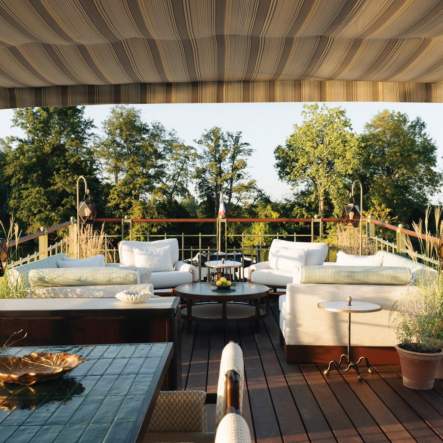 A view of the shaded outdoor lounge area at Les Bateaux Belond in France, a new dining experience on water with Dominique Crenn