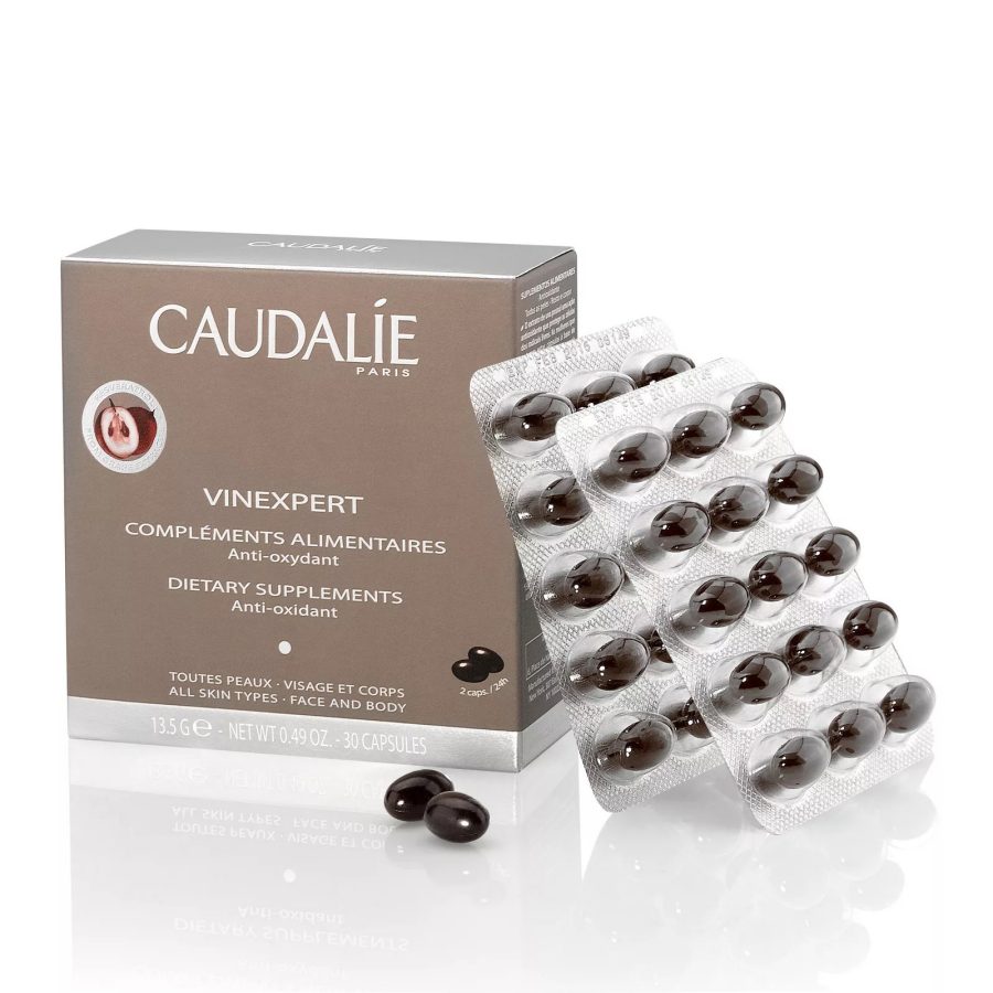 Two blister packs of Caudalie’s antioxidant dietary supplements next to a box.