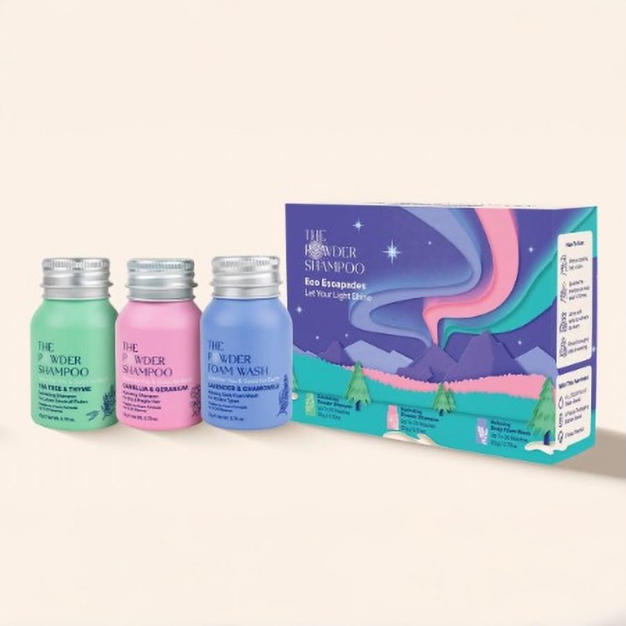 Three bottles of shampoo and body wash from The Powder Shampoo next to a box. 