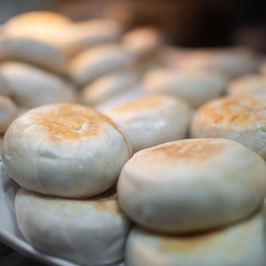 A closeup of platters of mending roubing Beijing-style meat pies.