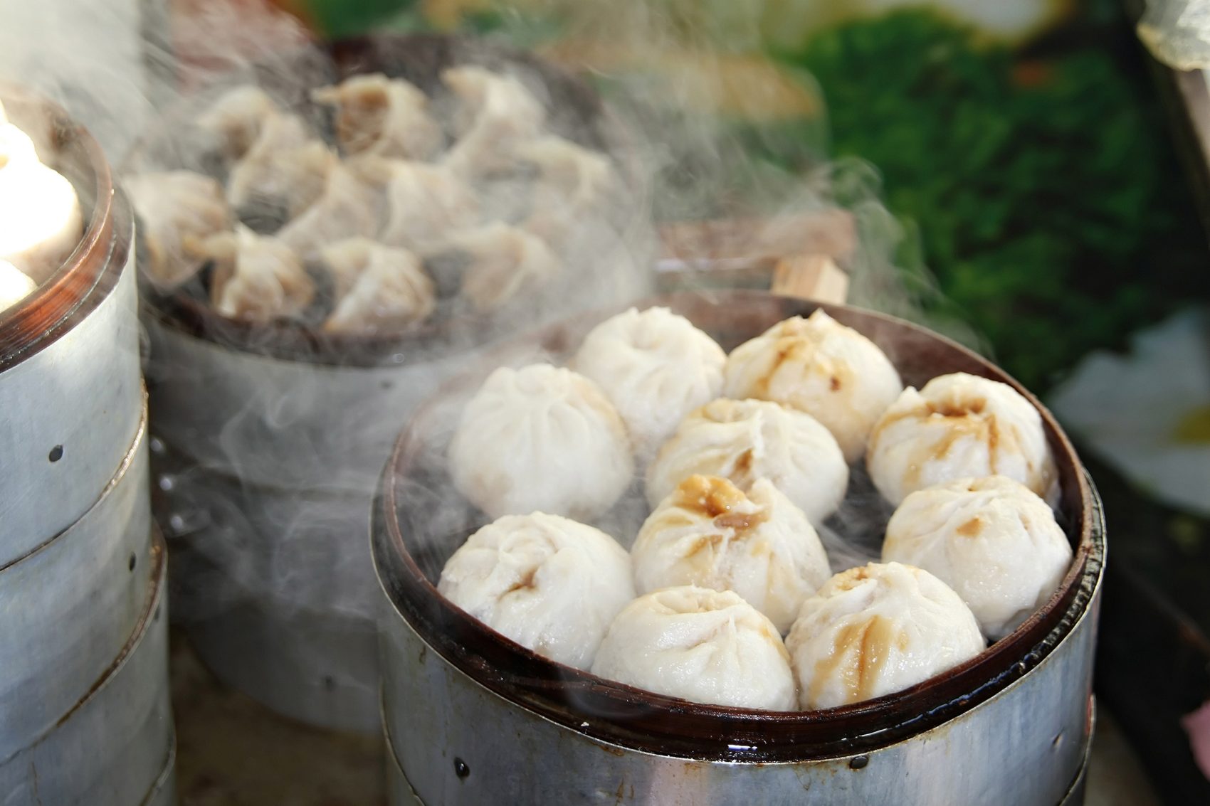Closeup of baskets of steaming hot baozi Chinese steamed buns found in Beijing.