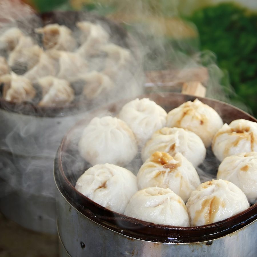 Closeup of baskets of steaming hot baozi Chinese steamed buns found in Beijing.