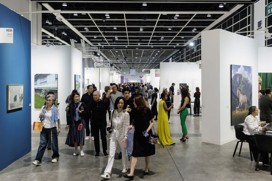 Crowds passing between booths at a Hong Kong art fair.