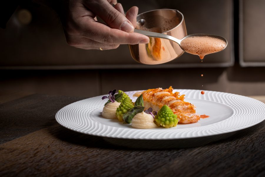 Close up of food being plated at the Pfistermühle restaurant in Munich.