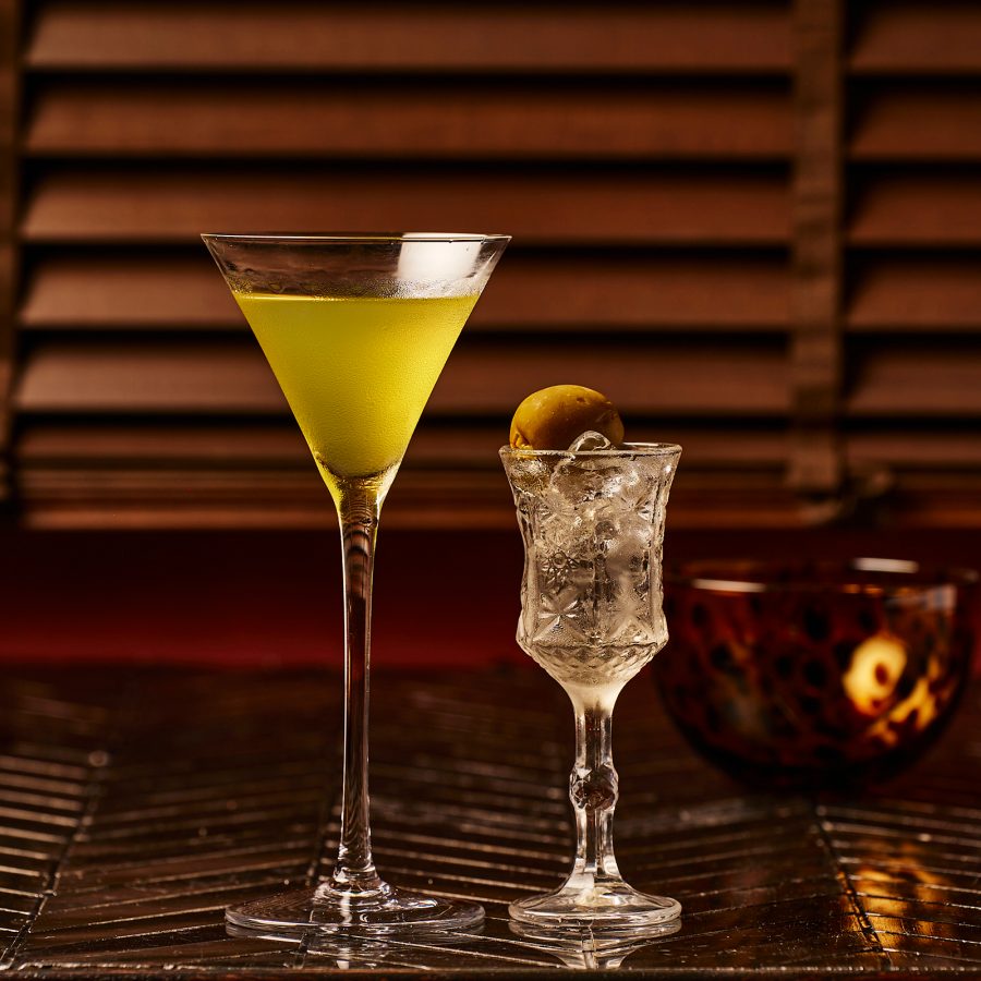 Two cocktails standing side by side on the countertop at DSK Cocktail Club.