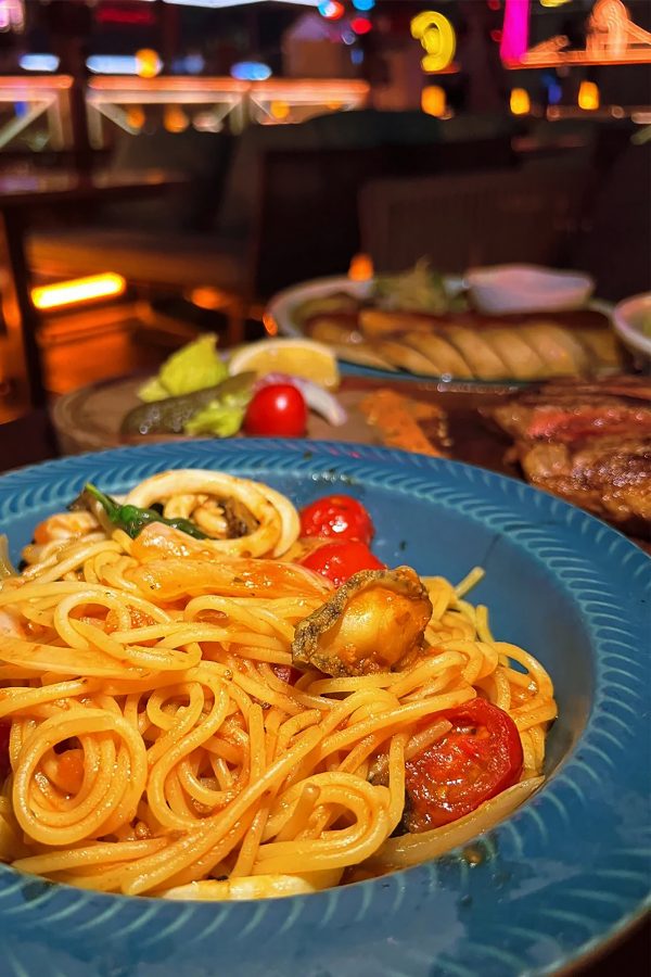 A plate of spaghetti in tomato sauce is placed on the table at RongEra. 