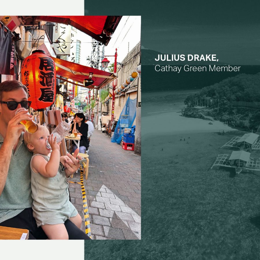Cathay Green Member Julius Drake on a street in Tokyo drinking a beer with his son