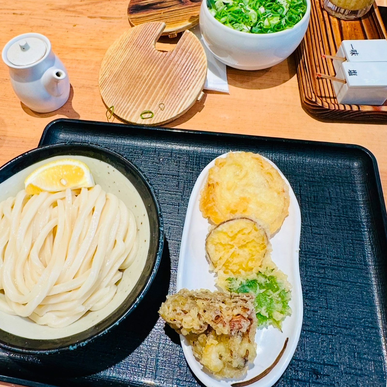 Thick udon noodles in a bowl alongside tempura at Hoshino in Tokyo.