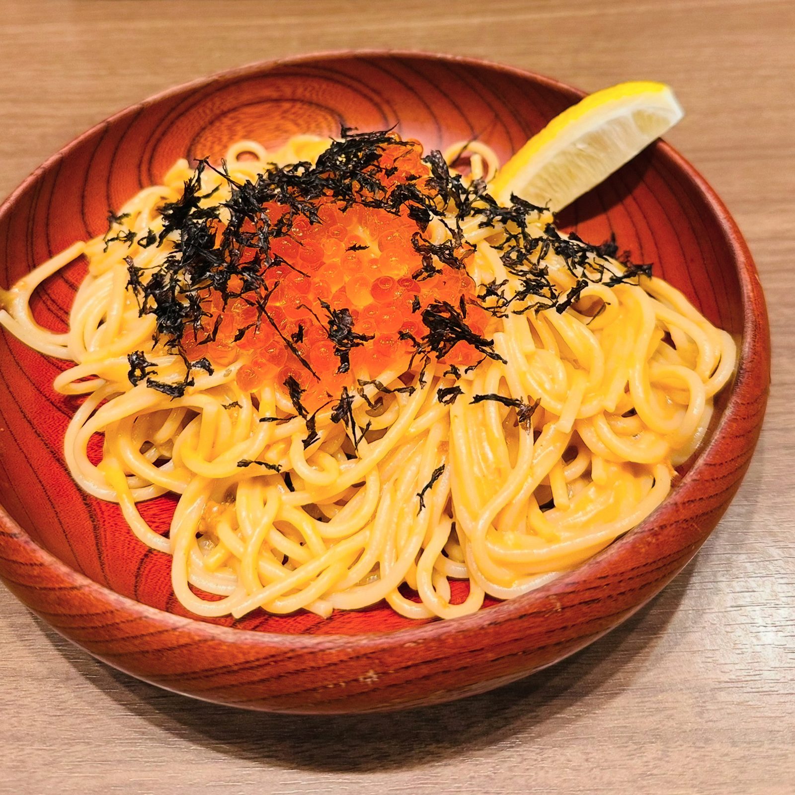 Close up view of a tarako and seaweed-topped pasta at Kabe no Ana in Tokyo. 