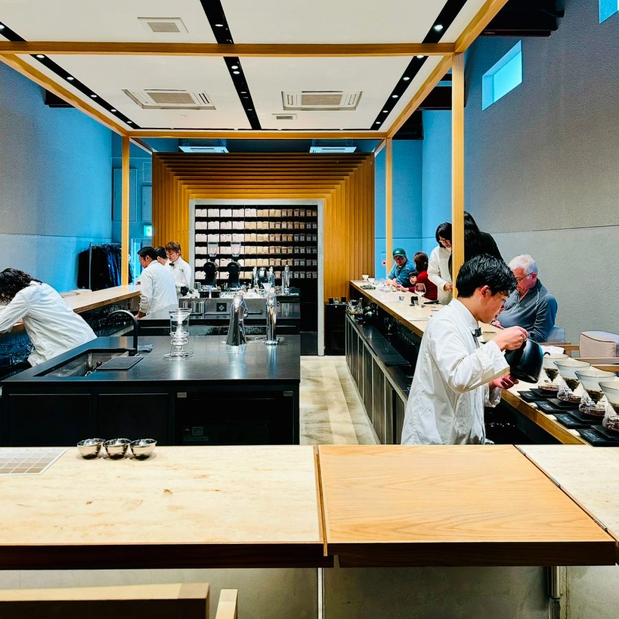 Baristas dressed in lab coats prepare drip coffees at Koffee Mameya in Tokyo. 