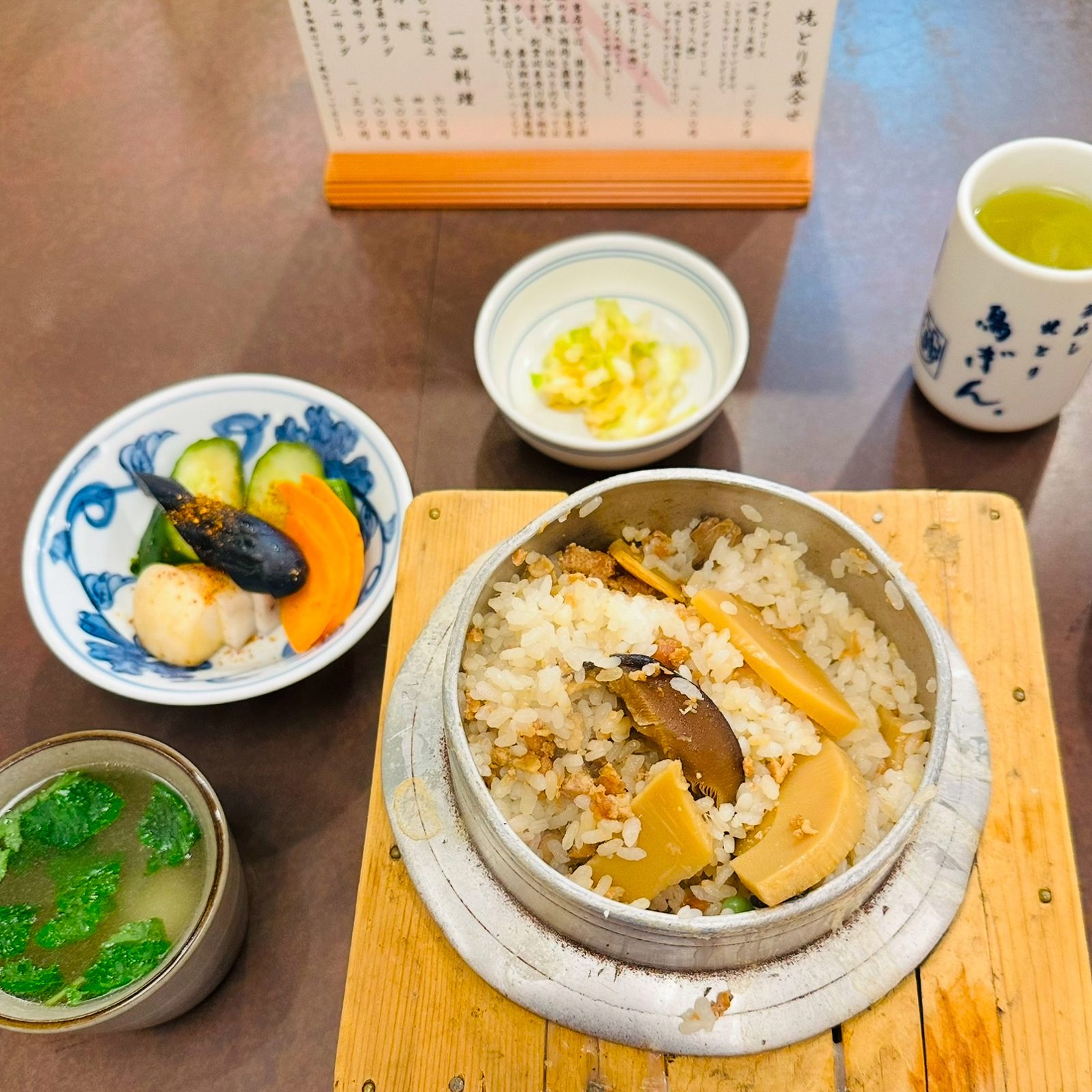 View of a kamameshi rice dish with mushrooms at Torigin Honten.