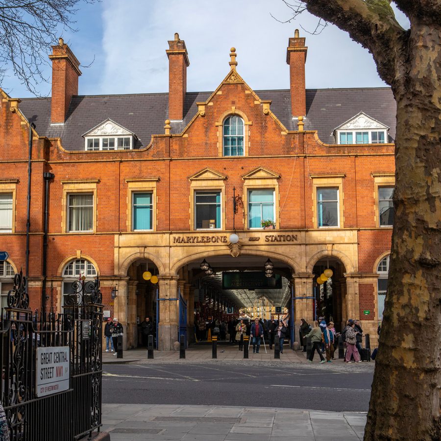 The exterior of Marylebone station is a tall rust-coloured building.