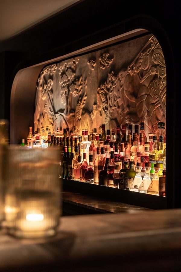 The bar at Château de Vignée and numerous bottles stacked up against the back wall.