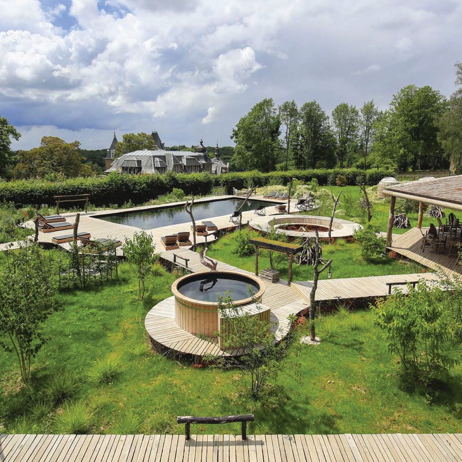 View of the green gardens, swimming pool and other facilities at the Domaine de Ronchinne in Belgium. 
