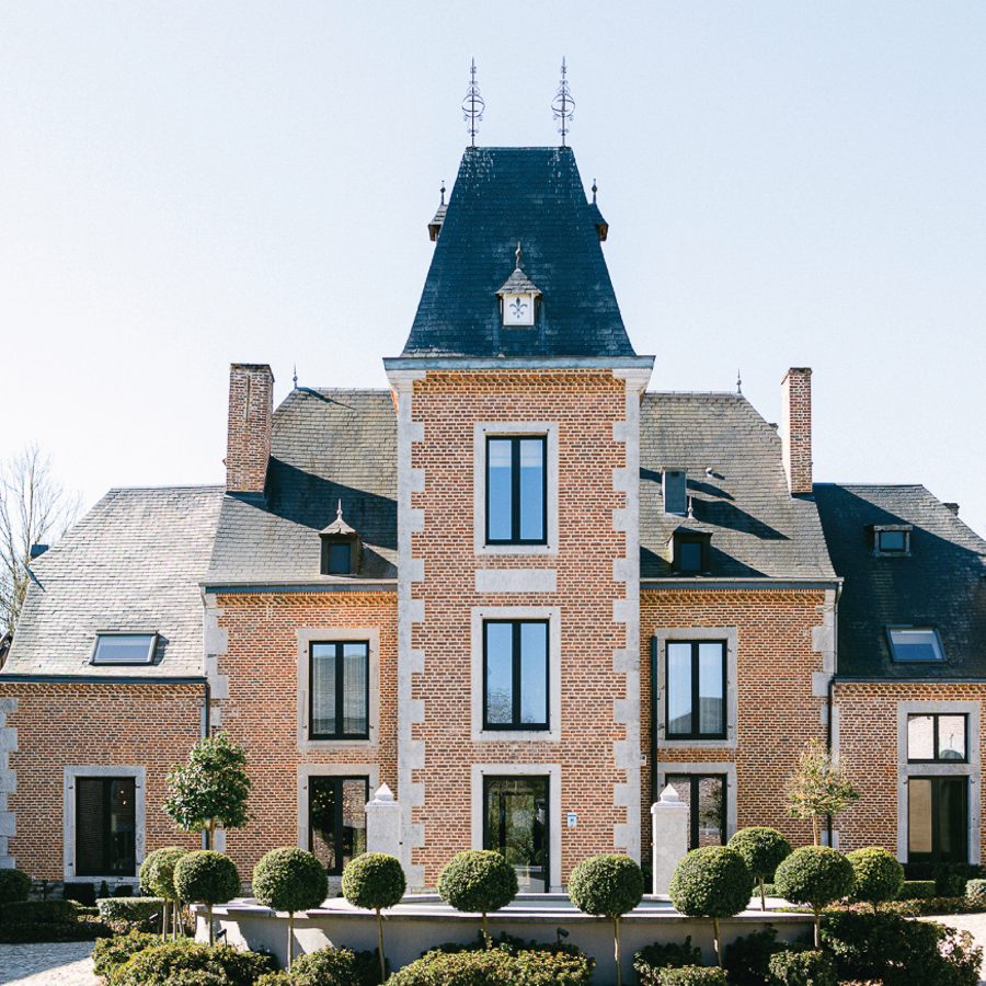 The exterior of Château de Vignée and its small garden feature outside.