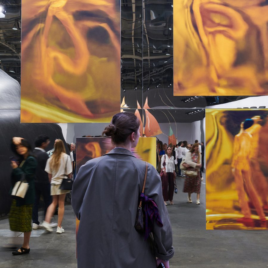 Interior view of artwork and spectators at Art Basel. 