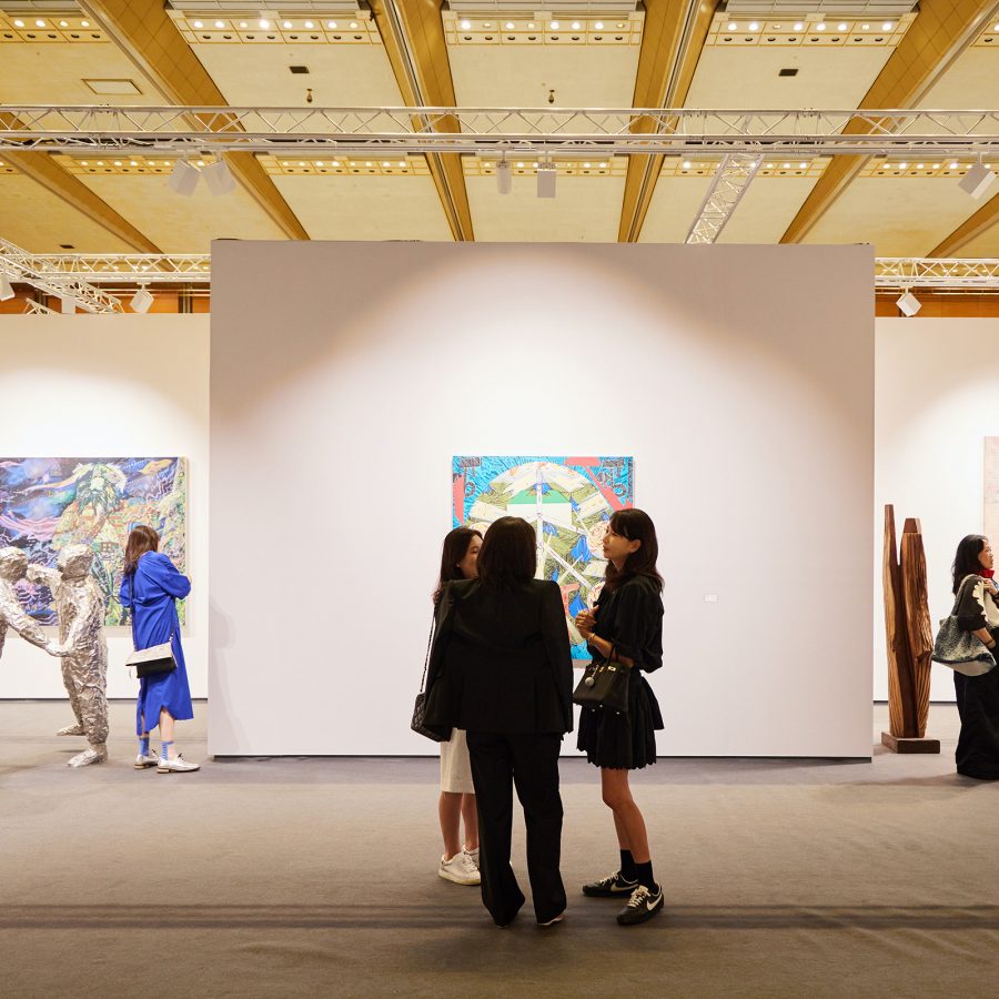 Interior view of visitors looking at paintings at Frieze Seoul in South Korea.