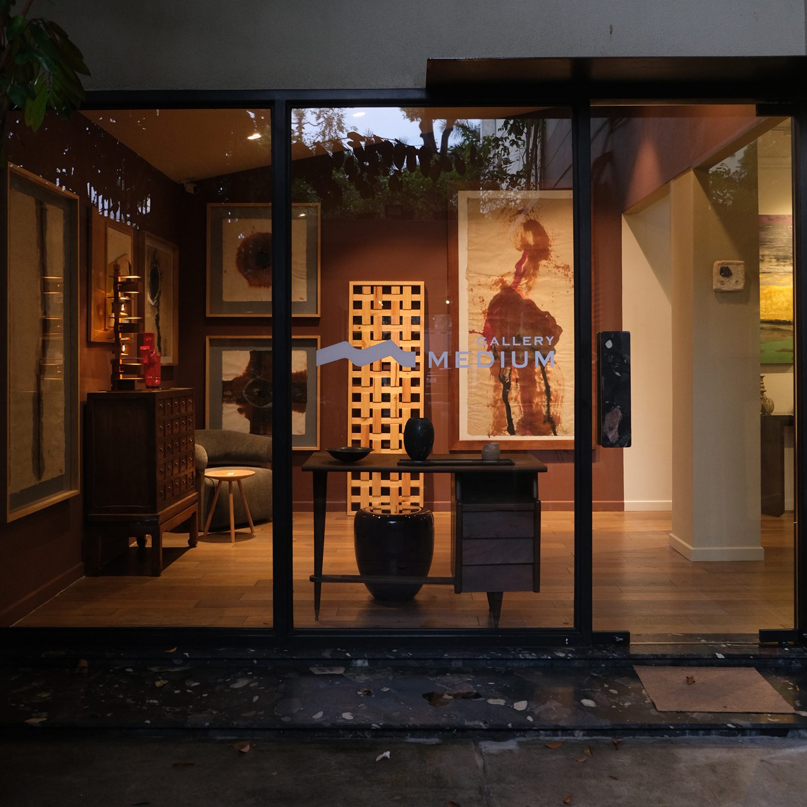 View of Gallery Medium and its artworks through its glass walls.