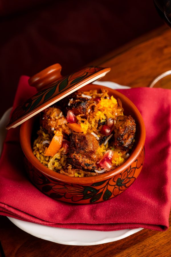 A tandoor dish in a clay pot on a red napkin at New Punjab Club, Hong Kong.