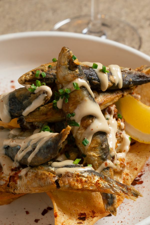 A closeup of a dish of fried fish with spices and sauce served at Lebanese restaurant Sumac, Hong Kong.