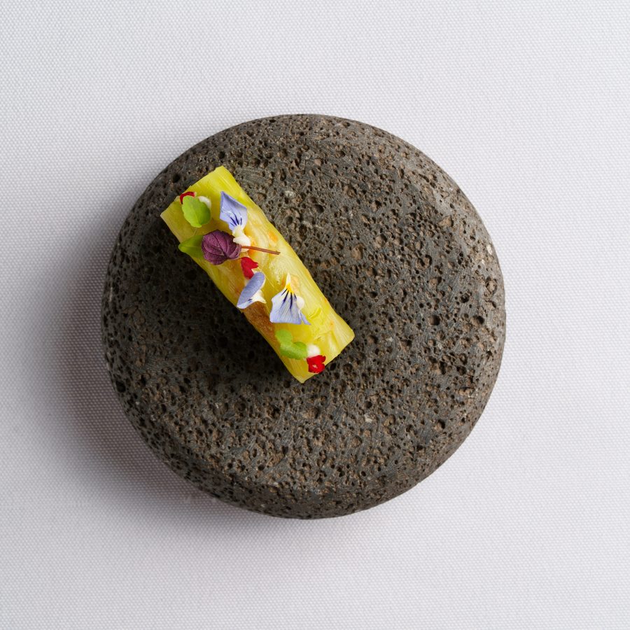 A flatlay of a vegetarian dish served on a rock at Yuan, Hong Kong. 